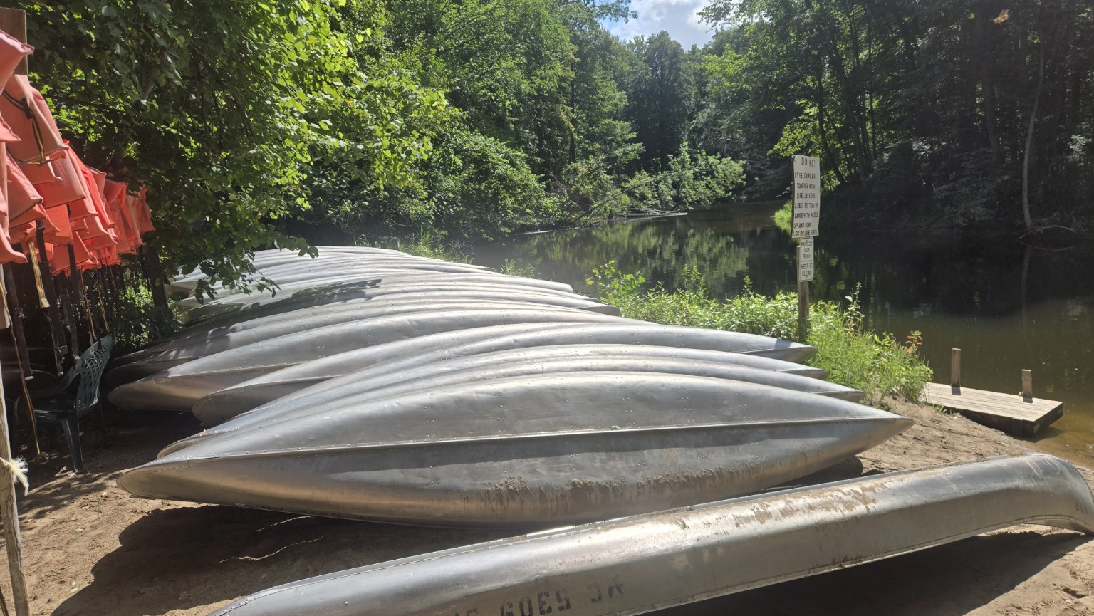 Tip-A-Thumb canoe fleet beside the Pinnebog River